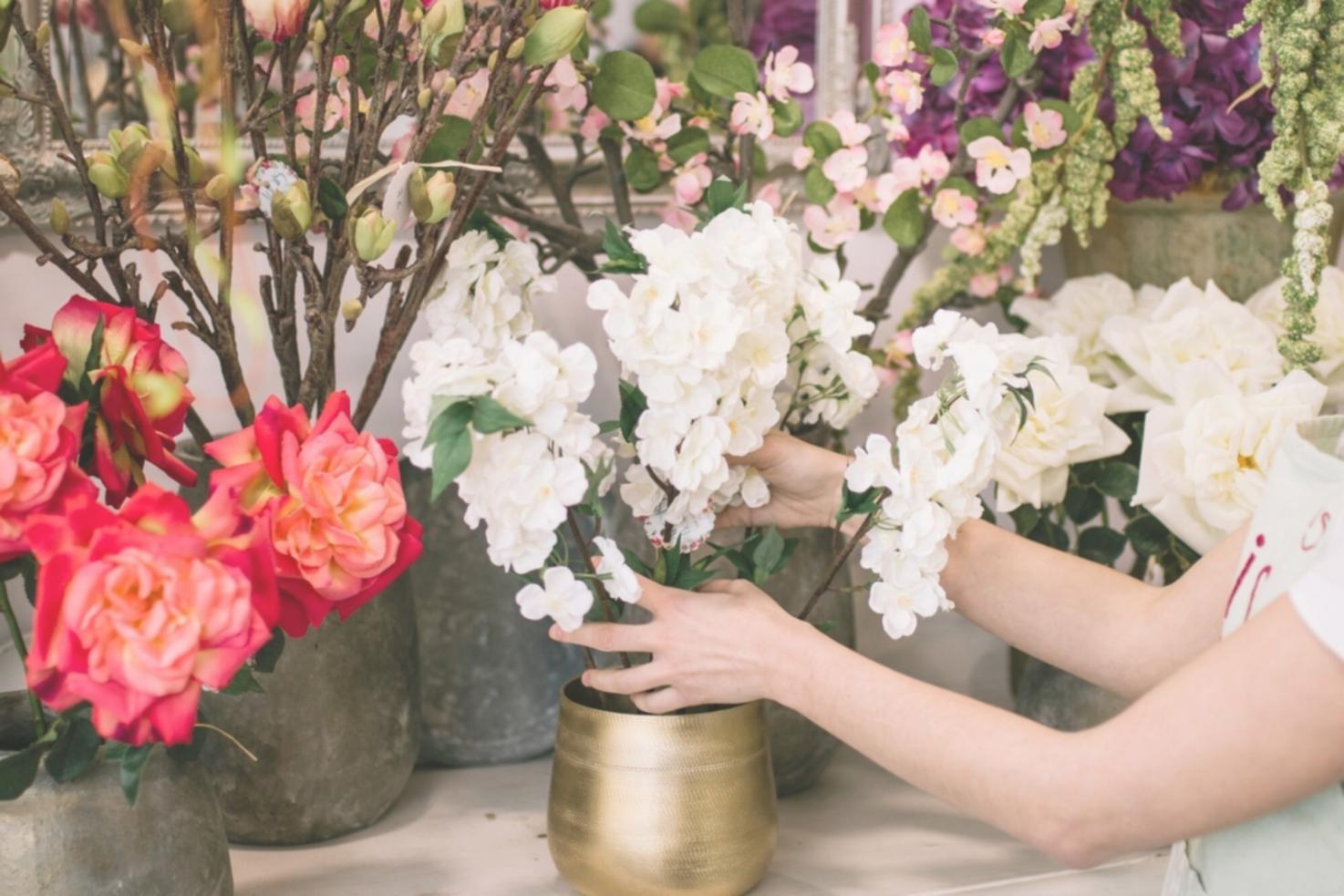 Fresh flowers being carefully selected for arrangement